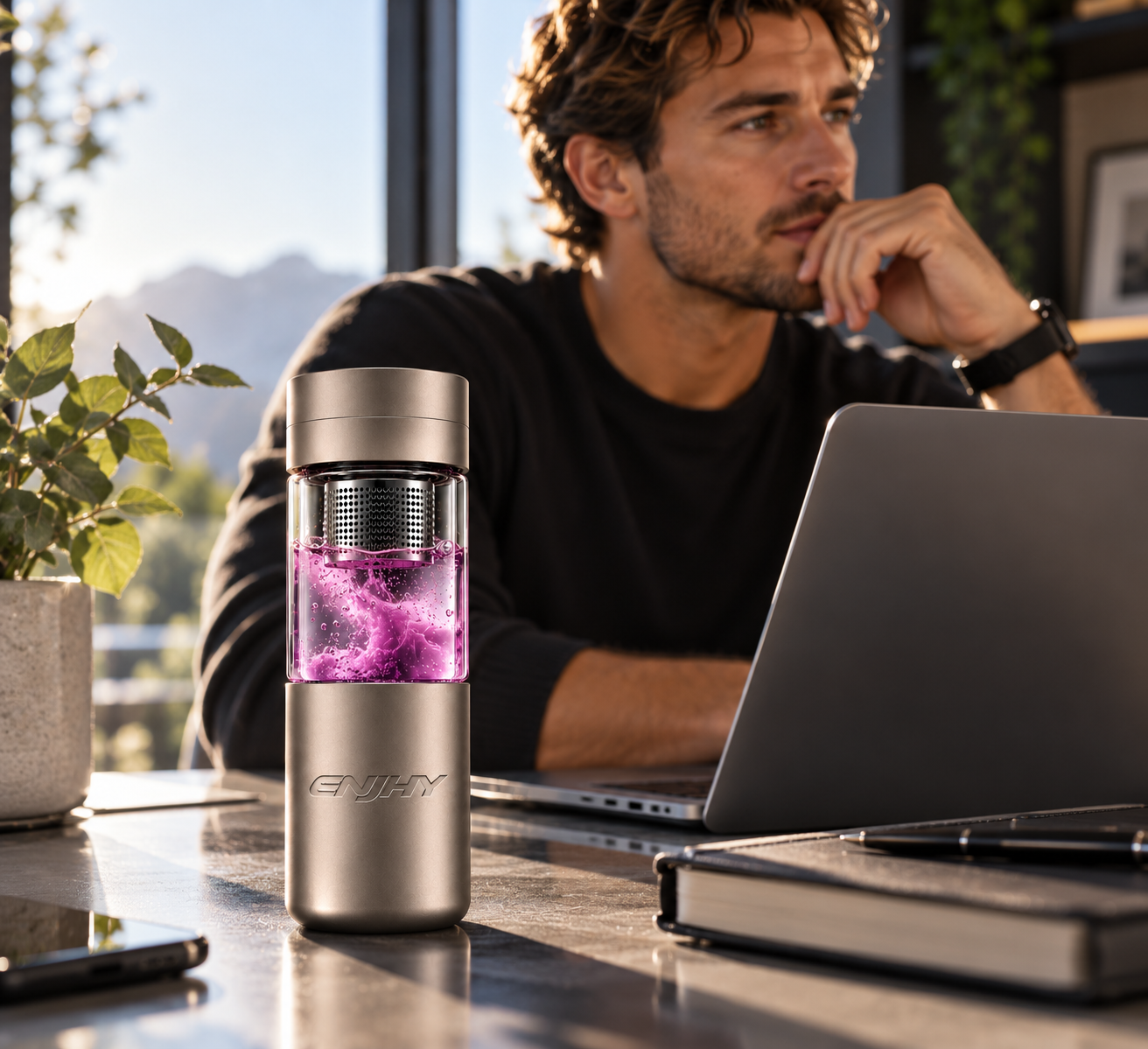 ENJHY Focus bottle with purple contents standing on a desk while a man works at a laptop
